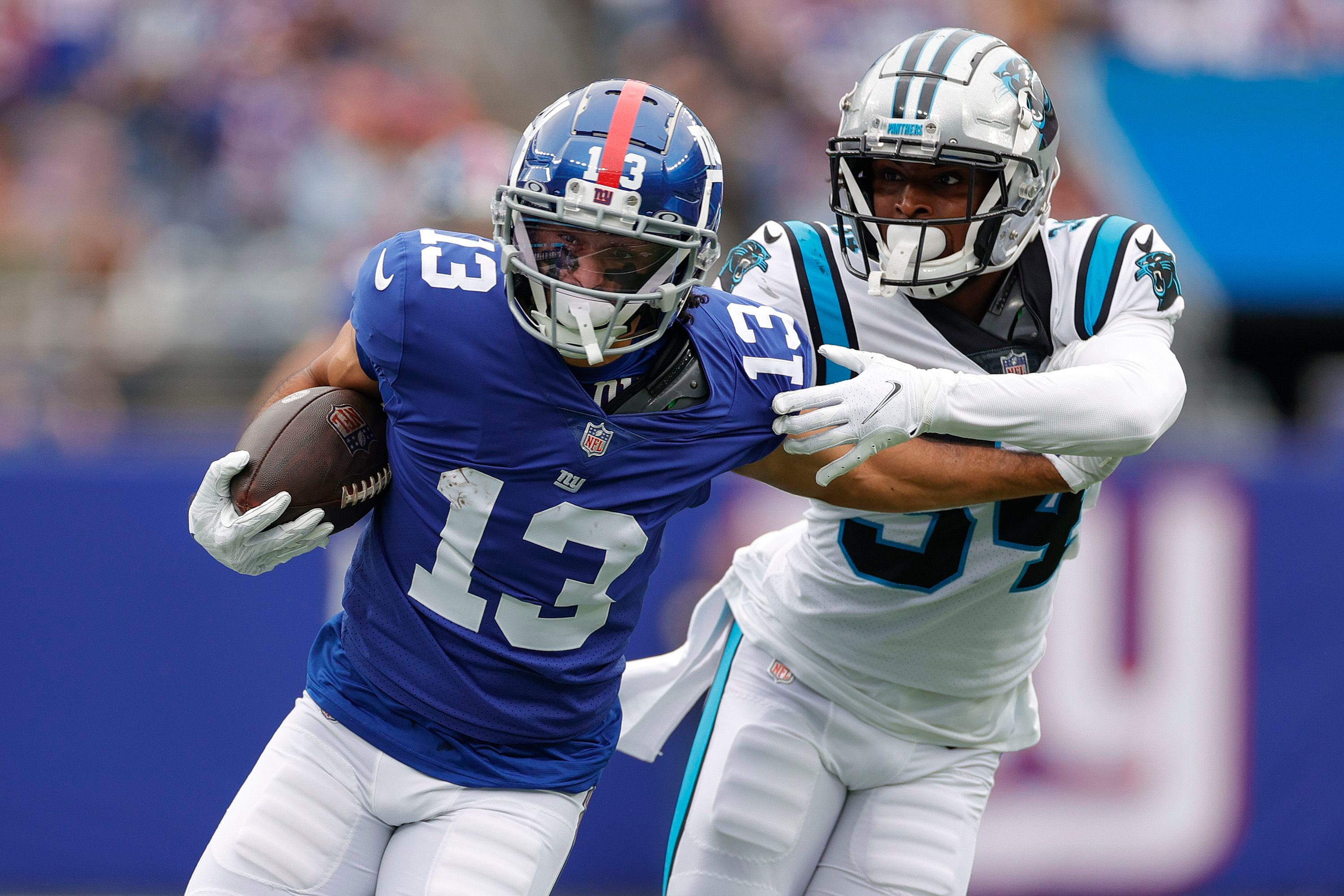 Jones passing and catching, Giants D spark win over Panthers