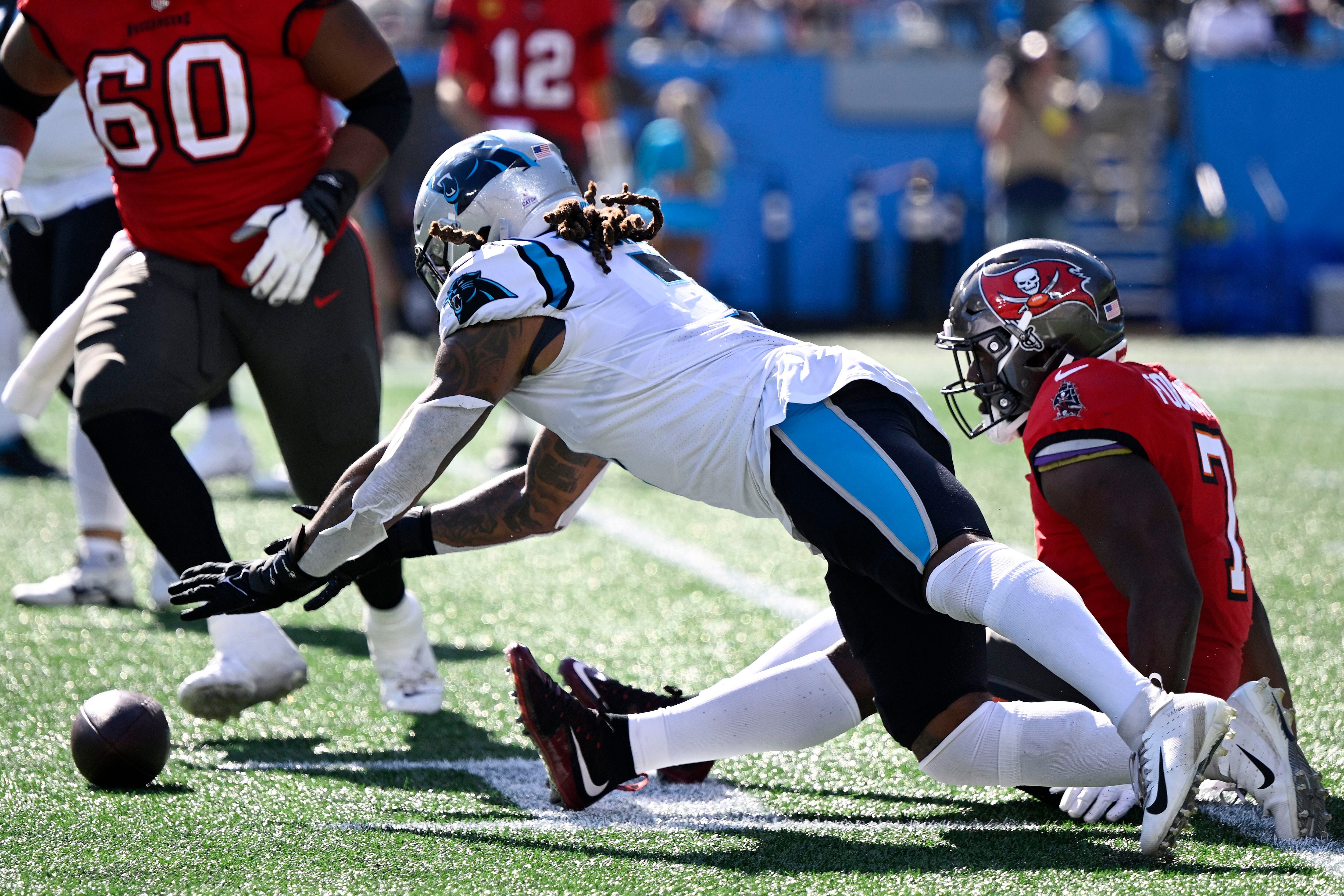 Carolina Panthers running back Chuba Hubbard (30) takes a handoff from  quarterback PJ Walker (11) during an NFL football game against the Tampa  Bay Buccaneers on Sunday, Oct. 23, 2022, in Charlotte